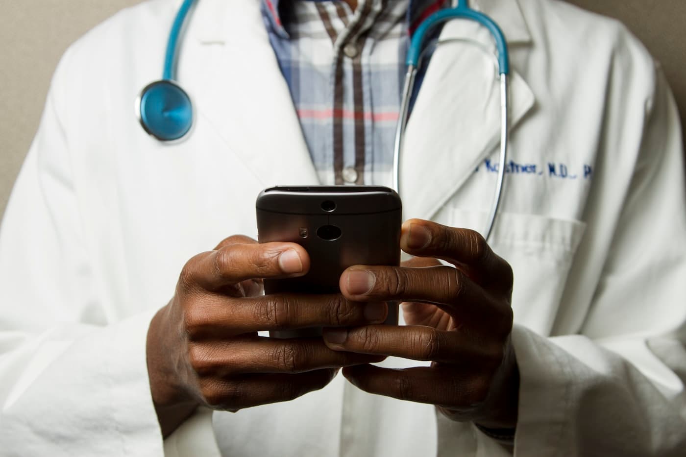 Health worker helping a patient access their records on a phone